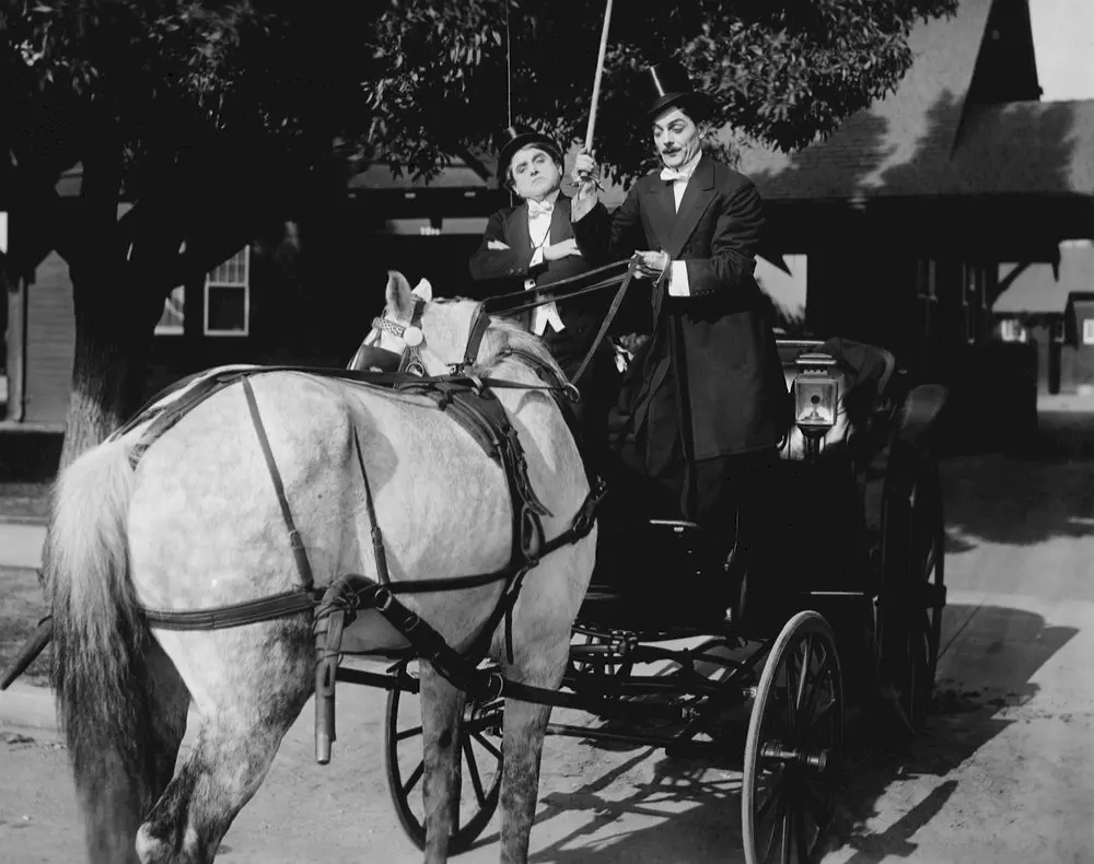 Gentlemen driving horse pulling cart
