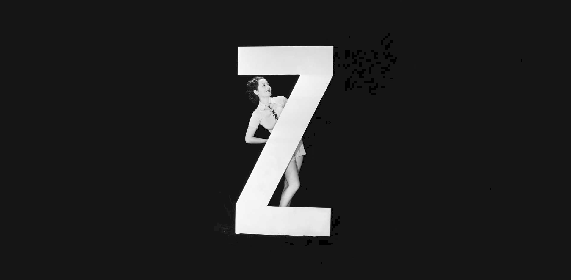 Image of a woman standing with the letter Z